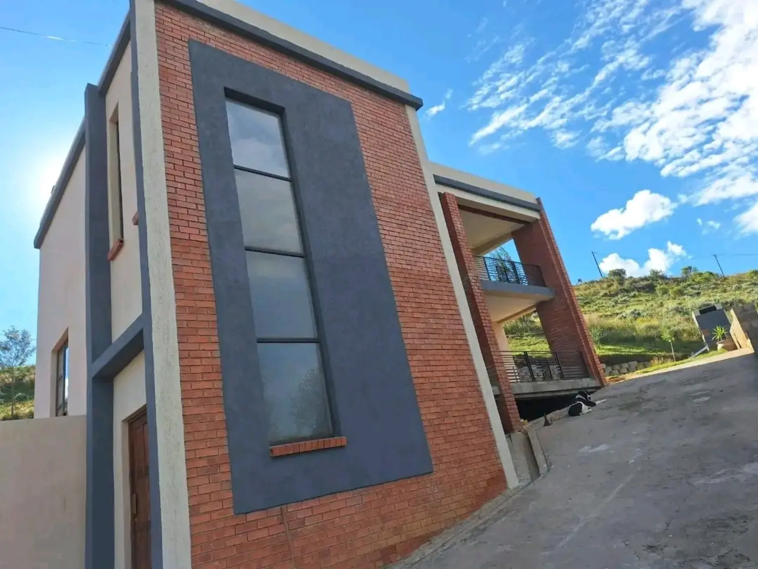Mamello exterior coating project on a modern brick and charcoal home